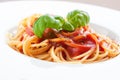 Tomato pasta spaghetti with fresh tomatoes, basil, italian herbs and olive oil in a white bowl Royalty Free Stock Photo