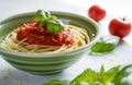 tomato paste on spaghetti in green ceramic bowl in white