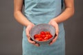 Tomato pieces in a bowl, prepare healthy food vegetables, holding fresh organic nutrition in the hands Royalty Free Stock Photo