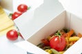 Tomato placed in a color pasta box Royalty Free Stock Photo