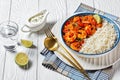 Tomato prawn curry with rice and yogurt, top view