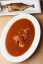 Tomato and prawn curry with fried mackerel