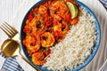 Tomato prawn curry with rice and yogurt, top view