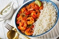 Tomato prawn curry with rice and yogurt, top view