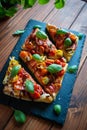 Tomato puff pastry tart with balsamic vinegar and fresh basil