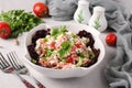 Tomato salad with cottage cheese, green onions, parsley and spices in a white bowl on gray background Royalty Free Stock Photo