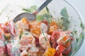 Tomato salad with sour cream and green dill in bowl with spoon. Healthy food concept Royalty Free Stock Photo