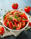 Tomato salad with spring onion and herbs in white bowl. Healthy summer food Royalty Free Stock Photo