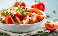 Tomato salad with spring onion and herbs in white bowl. Healthy summer food Royalty Free Stock Photo