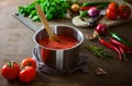 Tomato sauce in a pan on a kitchen table Royalty Free Stock Photo