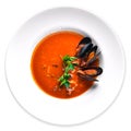Tomato and seafood creamy soup with mussels. On a wooden background. Top view.