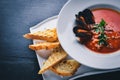 Tomato and seafood creamy soup with mussels.
