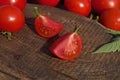 Tomato with slice on rustic wooden background. Fresh cut tomato  on wooden table Royalty Free Stock Photo