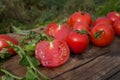 Tomato with slice on rustic wooden background. Fresh cut tomato  on wooden table Royalty Free Stock Photo