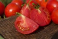 Tomato with slice on rustic wooden background. Fresh cut tomato  on wooden table Royalty Free Stock Photo