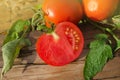 Sliced tomatoes on wooden table. Half  tomatoes on  wooden background Royalty Free Stock Photo