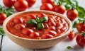 Tomato soup with basil in a wooden bowl on a white wooden table Royalty Free Stock Photo