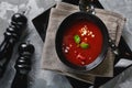 Tomato soup in a black bowl on a gray stone background. View from above. Copy space. Gray background. calm light. Food Royalty Free Stock Photo