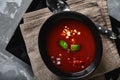 Tomato soup in a black bowl on a gray stone background. View from above. Copy space. Gray background. calm light. Food Royalty Free Stock Photo