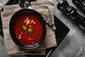 Tomato soup in a black bowl on a gray stone background. View from above. Copy space. Gray background. calm light. Food Royalty Free Stock Photo