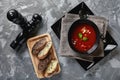 Tomato soup in a black bowl on a gray stone background. View from above. Copy space. Gray background. calm light. Food Royalty Free Stock Photo