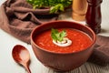 Tomato soup in a brown clay bowl with parsley on a white wooden background Royalty Free Stock Photo