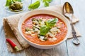 Tomato soup with feta cheese and pesto sauce in white bowl on wooden background Royalty Free Stock Photo