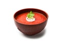 Tomato soup with parsley and milk cream in a brown bowl isolated on white background Royalty Free Stock Photo