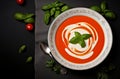 Tomato soup puree in a bowl with cream and fresh basil leaves. Top view Royalty Free Stock Photo