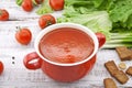 Tomato soup in red ceramic bowl on rustic wooden background. Hea Royalty Free Stock Photo