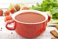 Tomato soup in red ceramic bowl on rustic wooden background. Hea Royalty Free Stock Photo