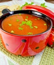 Tomato soup in red ware on napkin Royalty Free Stock Photo