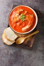 Tomato soup with river fish carp, vegetables and paprika close-up in a bowl. Vertical top view