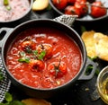 Tomato soup with roasted tomatoes, top view, black background Royalty Free Stock Photo