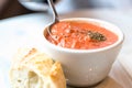 Tomato soup with spoon and bread