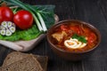 Tomato soup . Traditional Ukrainian beetroot and tomato soup - borsch in clay pot with sour cream, garlic, herbs and bread