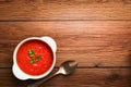 Tomato soup in a white bowl with parsley top view with copy space on a brown wooden background Royalty Free Stock Photo