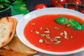 Tomato soup in a white plate with Basil Royalty Free Stock Photo