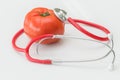 Tomato and stethoscope. Healthy food concept