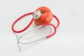 Tomato and stethoscope. Healthy food concept.