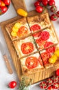 Tomato tart, puff pastry topped with cream cheese or ricotta and tomatoes. Royalty Free Stock Photo