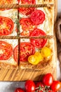 Tomato tart, puff pastry topped with cream cheese or ricotta and tomatoes. Royalty Free Stock Photo