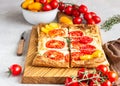 Tomato tart, puff pastry topped with cream cheese or ricotta and tomatoes. Royalty Free Stock Photo