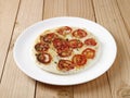 Tomato uthappam a traditional South Indian food on a wooden background