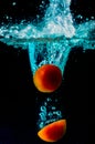 Tomato water splash on black background Royalty Free Stock Photo