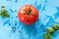 Tomato whith whater drops over on blue background