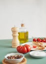 tomato wooden pepper mill and olive oil Royalty Free Stock Photo