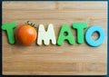 Tomato wooden word on chopping block Royalty Free Stock Photo