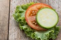 Tomato and zuchini slice on wood background, close-up Royalty Free Stock Photo