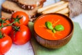 Tomatoe soup with bread sticks and basil on wooden background Royalty Free Stock Photo